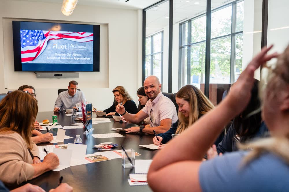 Colleagues write cards together during a workplace event