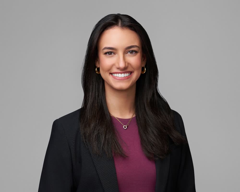 A finished, color-graded corporate headshot on a studio background